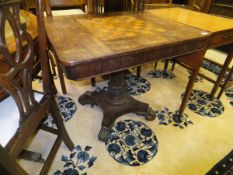 An early Victorian rosewood and inlaid games table, the chequerboard top sliding to reveal a recess,