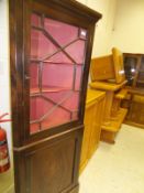 A reproduction mahogany corner cabinet