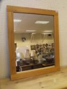 An oak framed rectangular wall mirror