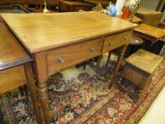 A Victorian mahogany side table with two drawers on turned and ringed legs