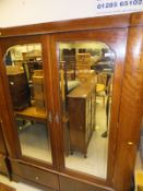 An Edwardian mahogany and inlaid double mirror door wardrobe with two drawers,