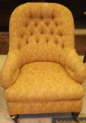 A Victorian buttoned upholstered salon armchair, with pale sand and terracotta floral upholstery,