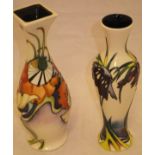 A Moorcroft pottery slim baluster shaped vase decorated with stylised purple flowers on a cream