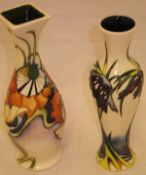 A Moorcroft pottery slim baluster shaped vase decorated with stylised purple flowers on a cream