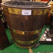 An oak and brass bound fireside bucket and a chestnut roaster