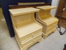 Two cream painted bedside tables with open recess above two drawers to bracket feet,