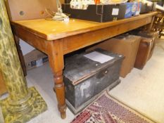 A rectangular pine dining table on turned legs