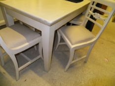 A white painted extending dining table, a set of five chairs,