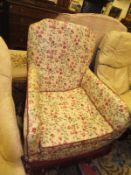 A circa 1900 upholstered armchair on square tapered legs to castors