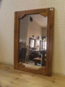 An oak framed rectangular wall mirror with shaped frame (TO BE SOLD WITH THE OPTION ON LOT 196)