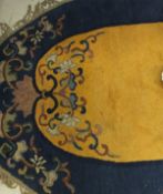 A Chinese rug of oval form,