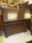 An 18th Century oak bureau, the sloping fall enclosing a basic fitted interior with well,