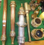 A collection of vintage copper and brass fire branch pipes and nozzles including a long branch pipe