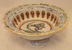 A 19th Century polychrome decorated Delft ware pedestal bowl of large proportions painted with a