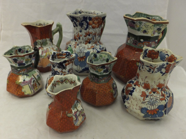 A collection of five ironstone red scale hydra jugs,