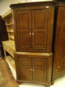 A 19th Century North Country English oak crossbanded freestanding corner cupboard in two sections