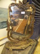An early 20th Century gilt framed dressing mirror in the Rococo taste