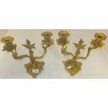 A pair of ormolu twin branch candelabra with all-over foliate decoration in the Rococo taste