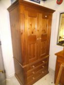 A pine two door wardrobe with three drawers,