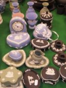 A collection of Wedgwood Jasper ware in pale blue, green, black and pink, to include vases, clock,