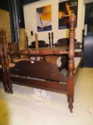 Two mahogany framed single bedsteads with carved finials