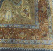 A Persian design carpet, the central panel set with floral sprays on a blue,