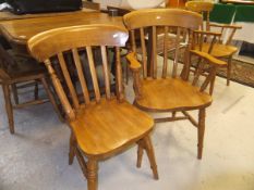 A set of eight (6 plus 2) stick back oak dining chairs with turned legs united by stretchers