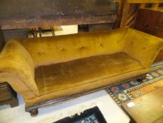A Victorian buttoned upholstered scroll arm sofa with moulded seat rail on turned supports