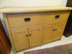 A pine enclosed dresser with camel coloured painted body of two drawers and four cupboard doors,
