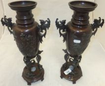 A pair of circa 1900 Japanese bronze vases depicting birds and flowers