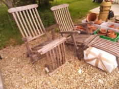 A pair of teak steamer chairs