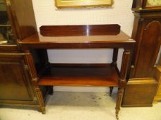 A Victorian mahogany dumb waiter of two tiers on turned and reeded supports to brass caps and