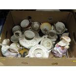 Two boxes of assorted decorative china wares to include tea wares, figurines, etc,