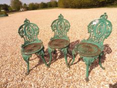 A set of three cast iron green painted garden chairs in the Coalbrookedale manner