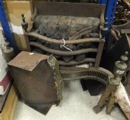 A circa 1900 iron and brass fire grate with serpentine front in the Regency taste