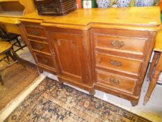 A Lincolnshire pine breakfront dresser with central cupboard door flanked by six drawers,