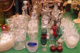 A large collection of various glass to include cut glass decanters, side plates, cranberry ware,