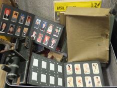 A suitcase containing an assortment of various vintage cigarette cards in albums,