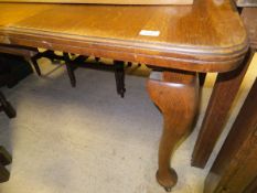 A circa 1900 oak rectangular dining table on cabriole legs to pad feet and castors