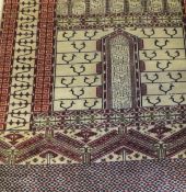 A Persian prayer rug, the central panel set with two pillars on a beige ground, within red,