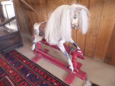 A late 19th / early 20th Century painted wooden rocking horse of small proportions,
