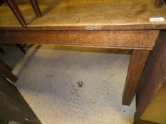 An oak rectangular dining table on square moulded supports