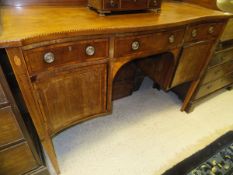 An Edwardian mahogany and barber pole strung serpentine fronted sideboard,