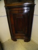 A 19th Century oak corner cupboard, the single panelled door enclosing three shelves,