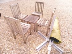 A set of four teak garden chairs and similar coffee table,