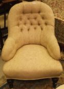 A Victorian buttoned upholstered salon armchair, with cream and taupe floral upholstery,