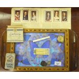 A marquetry inlaid and butterfly wing decorated tray, various cigarette cards,