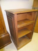 A Victorian oak bookcase of slim proportions with adjustable shelving on a plinth base