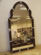 A 19th Century tortoiseshell and ivory veneered dome top wall mirror in the early 18th Century