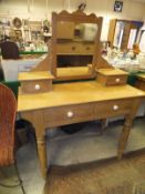 A pine dressing table with two drawers on turned legs